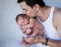 Father holding newborn baby kissing his head eyes closed Royalty Free Stock Photo
