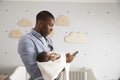 Father Holding Newborn Baby Son Using Mobile Phone Royalty Free Stock Photo