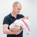 Father holding newborn daughter in her arms in the hall of the perinatal center Royalty Free Stock Photo