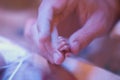 Father holding preemie hand