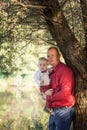 Father holding son on his arms, having fun outdoors in summer sunny day Royalty Free Stock Photo