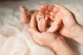 Father holds the feet of the newborn baby in his palms Royalty Free Stock Photo