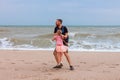 Father holds his cute daughter in arms, circles around himself, play have fun together on sea beach. Father s Day family Royalty Free Stock Photo