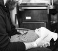 Father Holds Newborn Baby Boy Wrapped in a Blanket As He Looks up at His Dad. Black & White Photo Royalty Free Stock Photo