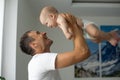 Father Hugging Newborn Baby in white bedroom. Royalty Free Stock Photo