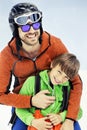 Father hugs his son affectionately in the snow Royalty Free Stock Photo