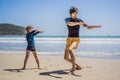 Father or instructor teaching his son how to surf in the sea on vacation or holiday. Travel and sports with children