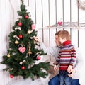 Father and kid decorating the Christmas tree