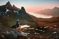 Father and kid hiking in Norway family enjoying mountains view with backpacks adventure travel healthy lifestyle