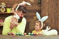 Father and kid painting Easter eggs. Rabbits family with bunny ears. Royalty Free Stock Photo