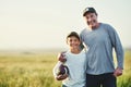 Father, kid portrait and rugby ball in countryside field for bonding and fun in nature. Mockup, dad and young child Royalty Free Stock Photo