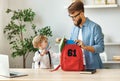 Father and kid preparing school backpack Royalty Free Stock Photo