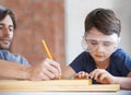 Father, kid and woodwork at home for project, bonding and building with safety gear. Dad, son and carpenter for Royalty Free Stock Photo