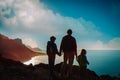 Father with kids-boy and girl- enjoy travel in sunset mountains Royalty Free Stock Photo