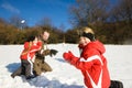 Father with kids having a snowball fight in winter Royalty Free Stock Photo