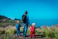 Father and kids hiking in nature, family in mountains near sea Royalty Free Stock Photo