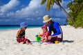 Father and kids making sand castle at tropical Royalty Free Stock Photo