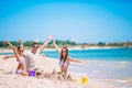 Father and kids making sand castle at tropical beach. Family playing with beach toys Royalty Free Stock Photo