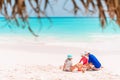 Father and kids making sand castle at tropical beach. Family playing with beach toys Royalty Free Stock Photo