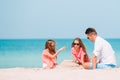 Father and kids making sand castle at tropical beach. Family playing with beach toys Royalty Free Stock Photo