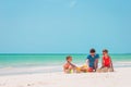 Father and kids making sand castle at tropical beach. Family playing with beach toys Royalty Free Stock Photo