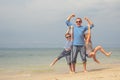 Father and children playing on the beach at the day time. Royalty Free Stock Photo