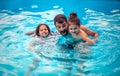 Father with kids playing in the pool Royalty Free Stock Photo