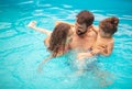 Father with kids playing in the pool Royalty Free Stock Photo