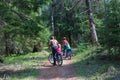 Father with kids riding bikes in nature Royalty Free Stock Photo