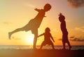 Father with kids silhouettes having fun at sunset Royalty Free Stock Photo