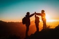 Father with kids travel in sunset mountains, family high five in nature Royalty Free Stock Photo