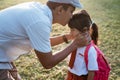 father kiss her daughter forehead when taking her to school in the morning Royalty Free Stock Photo