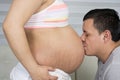 Father Kisses The Pregnant Tummy Of His Wife