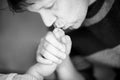 Father kissing foot of newborn baby. Royalty Free Stock Photo