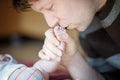 Father kissing foot of newborn baby. Royalty Free Stock Photo