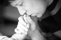 Father kissing foot of newborn baby. Royalty Free Stock Photo