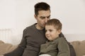 Father kissing his son. Dad loves his boy. Young attractive man and little caucasian kid have fun together. Interior and Royalty Free Stock Photo