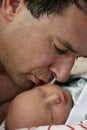 Father kissing infant