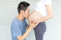 Father kissing pregnant mother`s belly. Man kissing the belly of his lovely pregnant wife Royalty Free Stock Photo