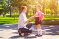 Father leads daughter to school in first grade. first day at school. back to school