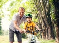 Father learn his son to ride bicykle
