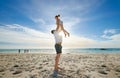 Father lifting daughter, having fun on the beach. A smiling young man playing with his cute little girl on vacation. Fun Royalty Free Stock Photo