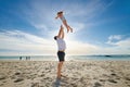 Father lifting daughter, having fun on the beach. A smiling young man playing with his cute little girl on vacation. Fun Royalty Free Stock Photo