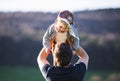 A father lifting his toddler son in the air outside in spring nature. Royalty Free Stock Photo