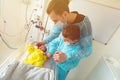 Father and brother with newborn child in ICU bed Royalty Free Stock Photo