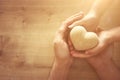 Father and little child holding together wooden heart. Happy father`s day concept Royalty Free Stock Photo