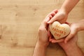 Father and little child holding together wooden heart. Happy father`s day concept Royalty Free Stock Photo