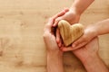 Father and little child holding together wooden heart. Happy father`s day concept Royalty Free Stock Photo