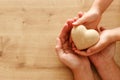 Father and little child holding together wooden heart. Happy father`s day concept Royalty Free Stock Photo