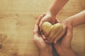 Father and little child holding together wooden heart. Happy father`s day concept Royalty Free Stock Photo